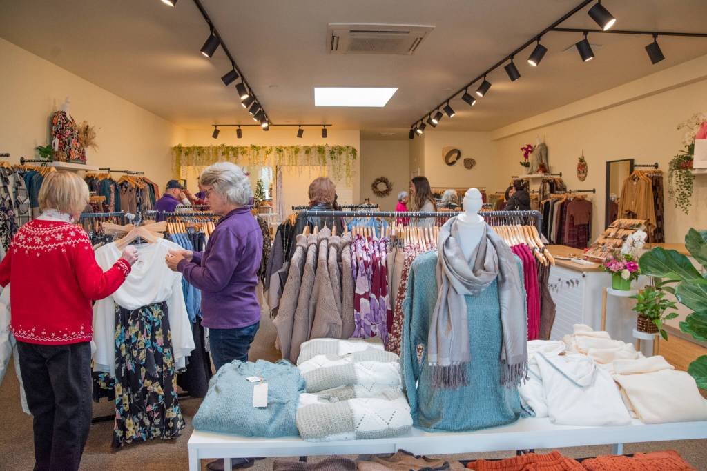 At the grand opening of Be Blossom Boutique on Nov. 30, Sequim-Dungeness Valley Chamber of Commerce members and other celebrants shop for womens clothing and jewelry.