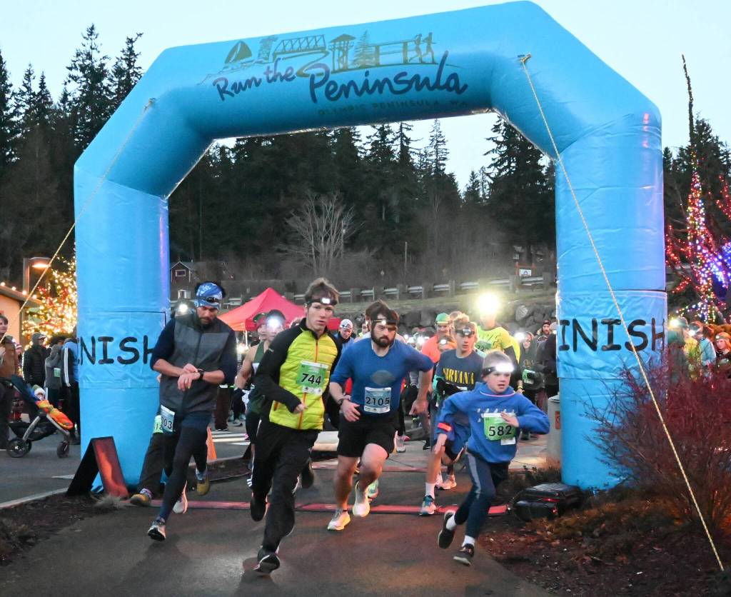 Sequim Gazette photo by Michael Dashiell / Runners break from the starting line of the 2022 Jamestown SKlallam Tribe 5k/10k race on Dec. 3.