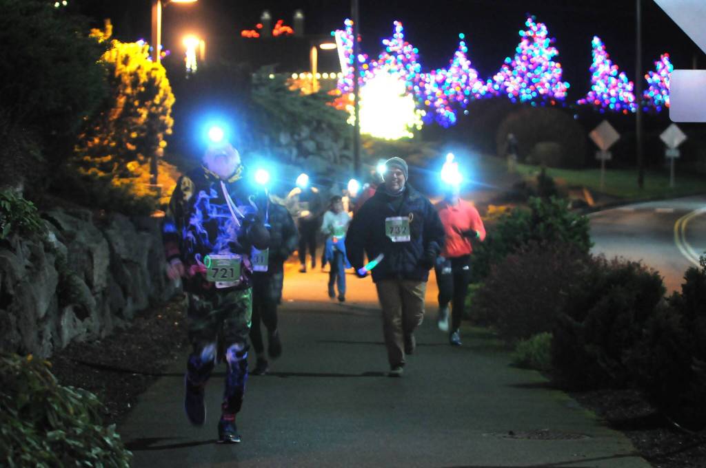Sequim Gazette photo by Michael Dashiell / Runners and walkers approach the finish line of the 2022 Jamestown SKlallam Tribe 5k/10k race in Blyn on Dec. 3.