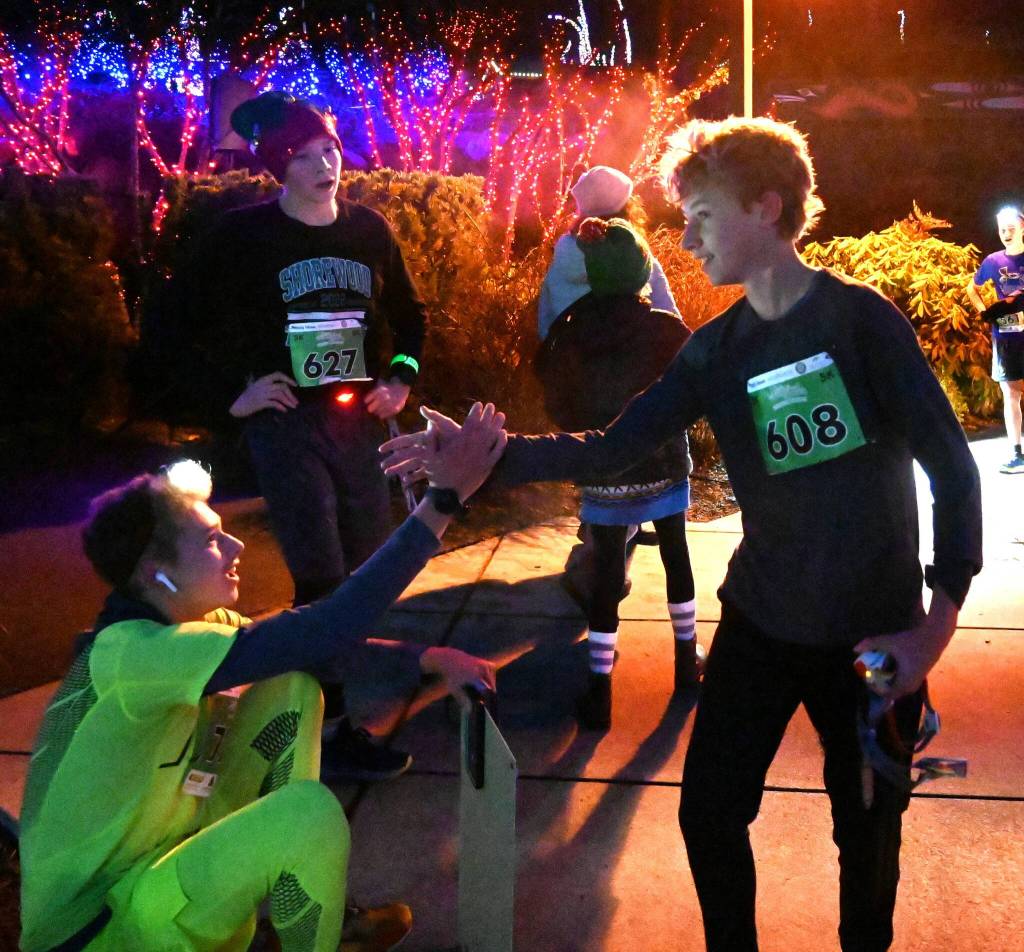 Port Townsends Noah Isenberg, right, and Noah Plotnik of Sequim, center, congratulate Sean Southard of Sequim for is 2022 Jamestown SKlallam Tribe 5k victory on Dec. 3.