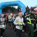 Sequim Gazette photoS by Michael Dashiell
Runners and walkers cross the starting line at the 2022 Jamestown SKlallam Tribe 5k/10k race on Dec. 3. Many participants, including Timea Tihanyi of Seattle (553), wore holiday-themed costumes and flair.