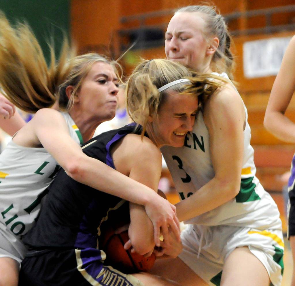 Sequim Gazette photo by Michael Dashiell
Sequim Highs Hannah Wagner views for the ball as Lyndens Claire Devries, left, and Mya VanderYacht try to pry the ball away in a state regional playoff game at Mount Vernon High School on Feb. 25.