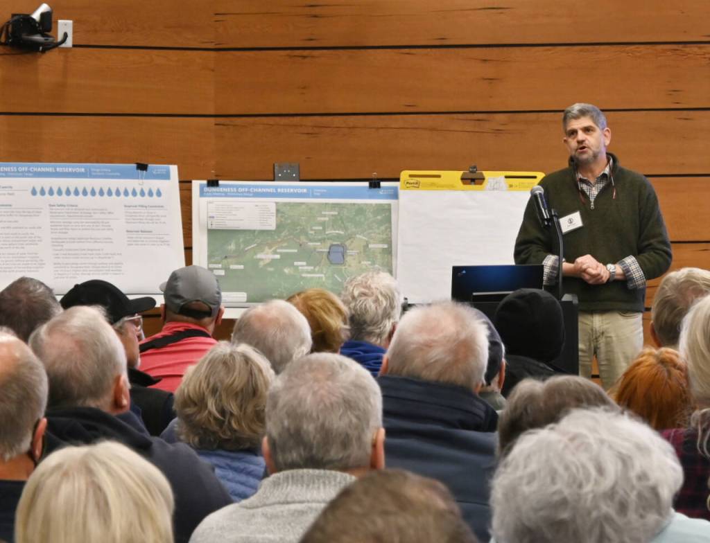 Sequim Gazette photo by Michael Dashiell Clallam County commissioner Mark Ozias introduces the Dungeness Off-Channel Reservoir projects initial design to a crowded conference room at the Dungeness River Nature Center conference room on Dec. 6.