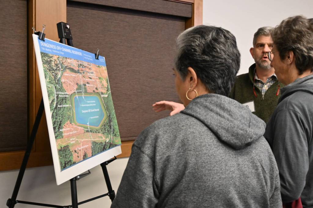 Sequim Gazette photo by Michael Dashiell Clallam County commissioner Mark Ozias talks about aspects of the Dungeness Off-Channel Reservoir to attendees of an open house at the Dungeness River Nature Center on Dec. 6.