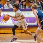 Sequim Gazette photo by Emily Matthiessen Sequims Solomon Sheppard, left, pushes the ball upcourt in the Wolves Dec. 6 Olympic League home game against 3A Bainbridge. Spartan Sam Nylund pursues the play. Bainbridge won, 62-35.