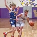 Sequim Gazette photo by Emily Matthiessen Sequims Zackary Thompson, right, looks to dribble past Bainbridges Sam Nylund in Sequims Olympic League match-up with the 3A Spartans on Dec. 6.