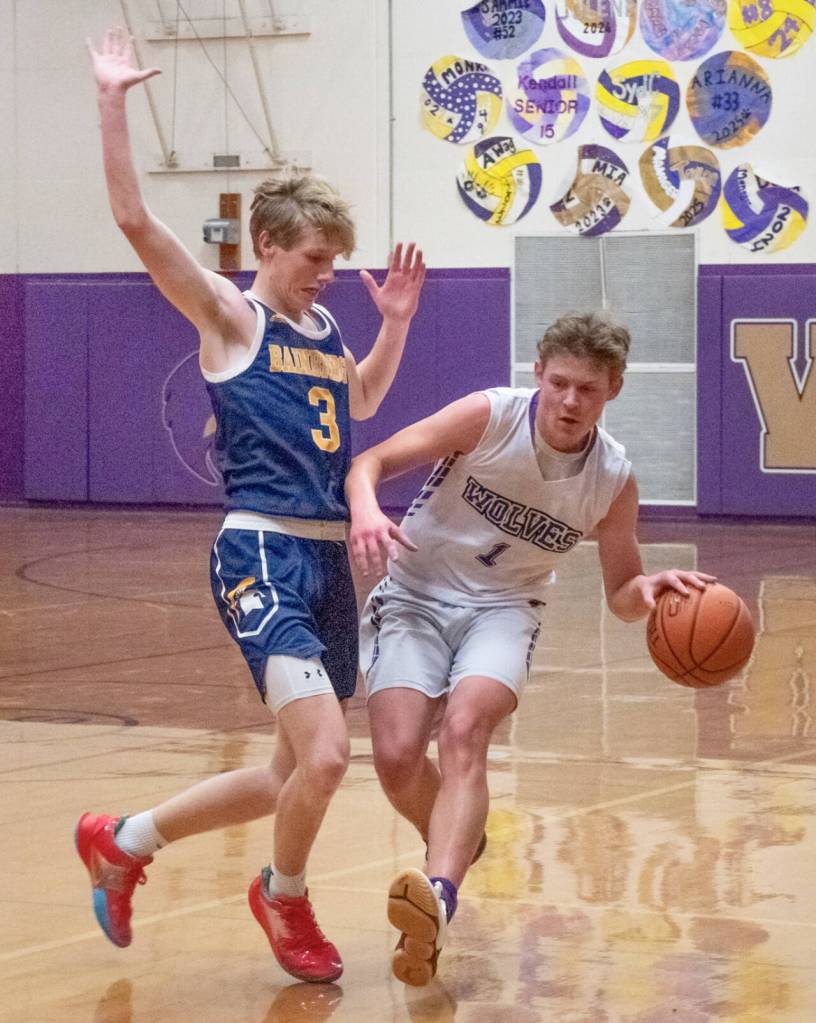 Sequim Gazette photo by Emily Matthiessen Sequims Zackary Thompson, right, looks to dribble past Bainbridges Sam Nylund in Sequims Olympic League match-up with the 3A Spartans on Dec. 6.