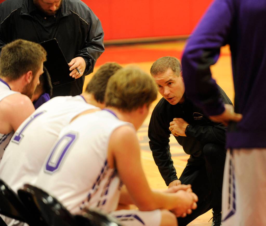 Sequim Gazette file photo by Conor Dowley 
Sequim High head coach Greg Glasser, center, talks to Isaiah Moore, left, and Erik Christiansen during a timeout in the Wolves 51-46 win over North Mason in January 2020.