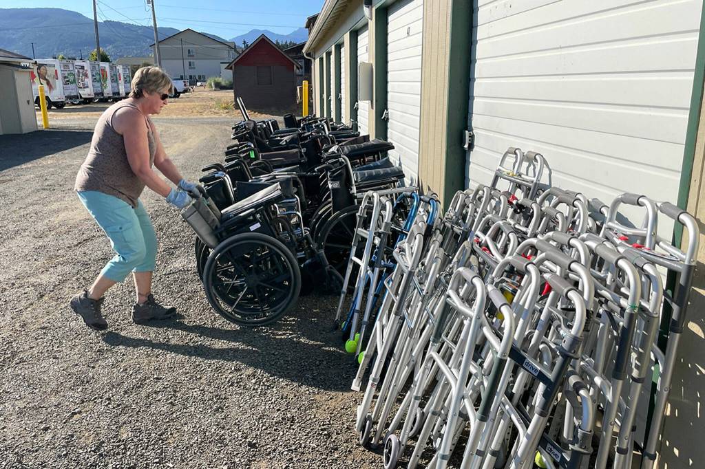 Sequim Gazette photo by Matthew Nash/ Jackie Ragghianti helps fellow Dungeness Community Church attendees organize wheelchairs, walkers and more on Sept. 20 at All-Safe Mini-Storage, with equipment to be shipped to Guatemala to help people with mobility issues.