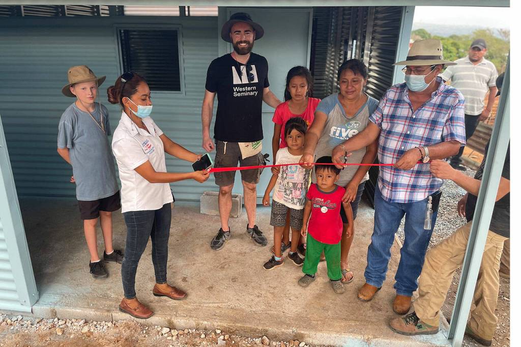 Photo courtesy of David Piper/ Locals hold a ribbon cutting for the new home of Margarita Chuga, second from right, and her three children. She was widowed last year, and the late-Mike Piper paid for it before his passing and his son David, third from left, wanted to help build it in Chiquimulilla, Guatemala.