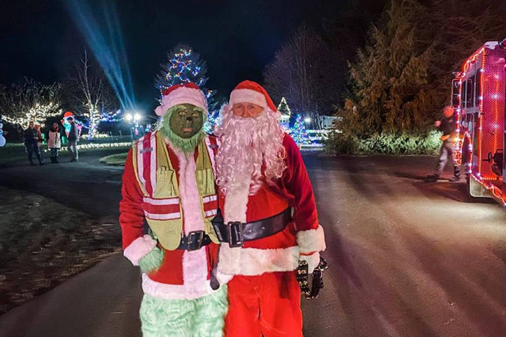 Photo courtesy Santas Toy and Food Fire Brigade/ The Grinch and Santa (Brandon Tucker and Dan Orr) make an appearance during the first night, Dec. 5, of Santas Toy and Food Fire Brigade. It toured through Sequim collecting donations for Sequim Community Aid and Sequim Food Bank through Dec. 9.