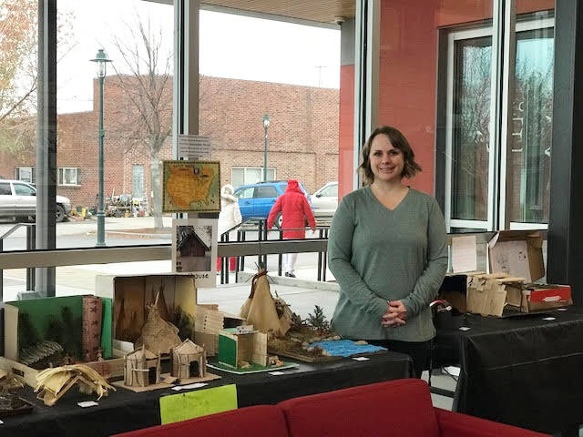 Submitted photo / Olympic Peninsula Academy teacher Rebecca Bullard stands near student dioramas, on display at the Sequim Civic Center through the first week of January.