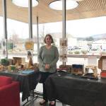 Submitted photo / Olympic Peninsula Academy teacher Rebecca Bullard stands near student dioramas, on display at the Sequim Civic Center through the first week of January.