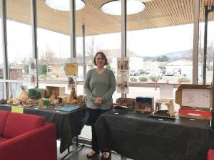 Submitted photo / Olympic Peninsula Academy teacher Rebecca Bullard stands near student dioramas, on display at the Sequim Civic Center through the first week of January.