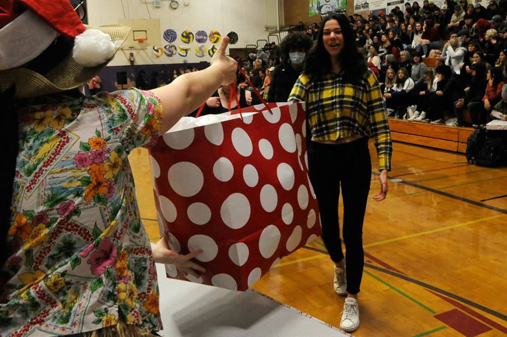 Matthew Nash/ Sequim Gazette photos
Becca Van Dyken hands Emily Post a present (stuffed animal) during the Winter Wishes assembly on Dec. 13. Post and hundreds of students received gifts through donations made from the community, classmates and school staff.