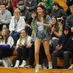 Sequim Gazette photo by Matthew Nash/ Danica Chen stands to receive her gift of knitted mittens from teacher Laura Gould during the Winter Wishes assembly.