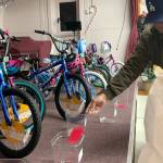 Sequim Gazette photo by Matthew Nash/ Keith Brown of Sequim puts a raffle ticket in a bin for a parent during Toys for Sequim Kids. On why he continues to volunteer: I just enjoy seeing the looks on peoples faces, he said. It (feels good) knowing were giving back.