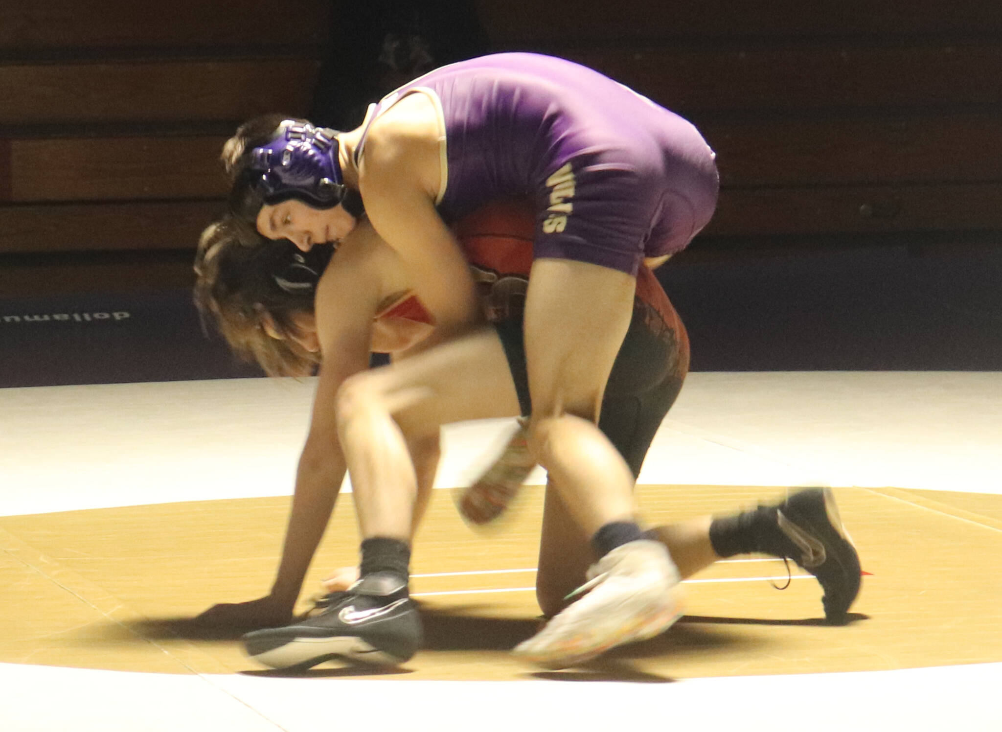 Photo by Roger Burwash / Sequims Cayden Beauregard, top, takes on a Kingston wrestler in the 113-pound weight class in the Wolves Dec. 14 home league meet.