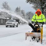 Sequim Gazette photo by Michael Dashiell / City of Sequim staffer Ryan Ross clears snow from the sidewalk on north Sequim Avenue on Dec. 20.