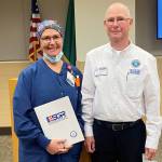 Photo courtesy of Olympic Medical Center / Sarah Winfield, OMC Manager of Surgical Services Sarah Winfield, left, accepts the Patriot Award from Phil Sanders, Washington State Chair of the Employer Support of the Guard and Reserve.