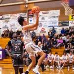 Sequim Gazette photo by Emily Matthiessen / Sequims Isaiah Moore drives past WF Wests Brian Anouma in a Dec. 27 non-league contest in Sequim. WF West won, 60-44.