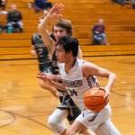 Sequims Isaiah Moore drives past a WF West defender in a Dec. 27 game. Moore led the Wolves with 14 points.