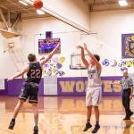 Sequim Gazette photo by Emily Matthiessen / Sequims Keenan Green, right, puts up a long-range shot in over WF Wests Lucas Hoff in the second half of the Wolves 60-44 loss to the visiting Bearcats on Dec. 27.