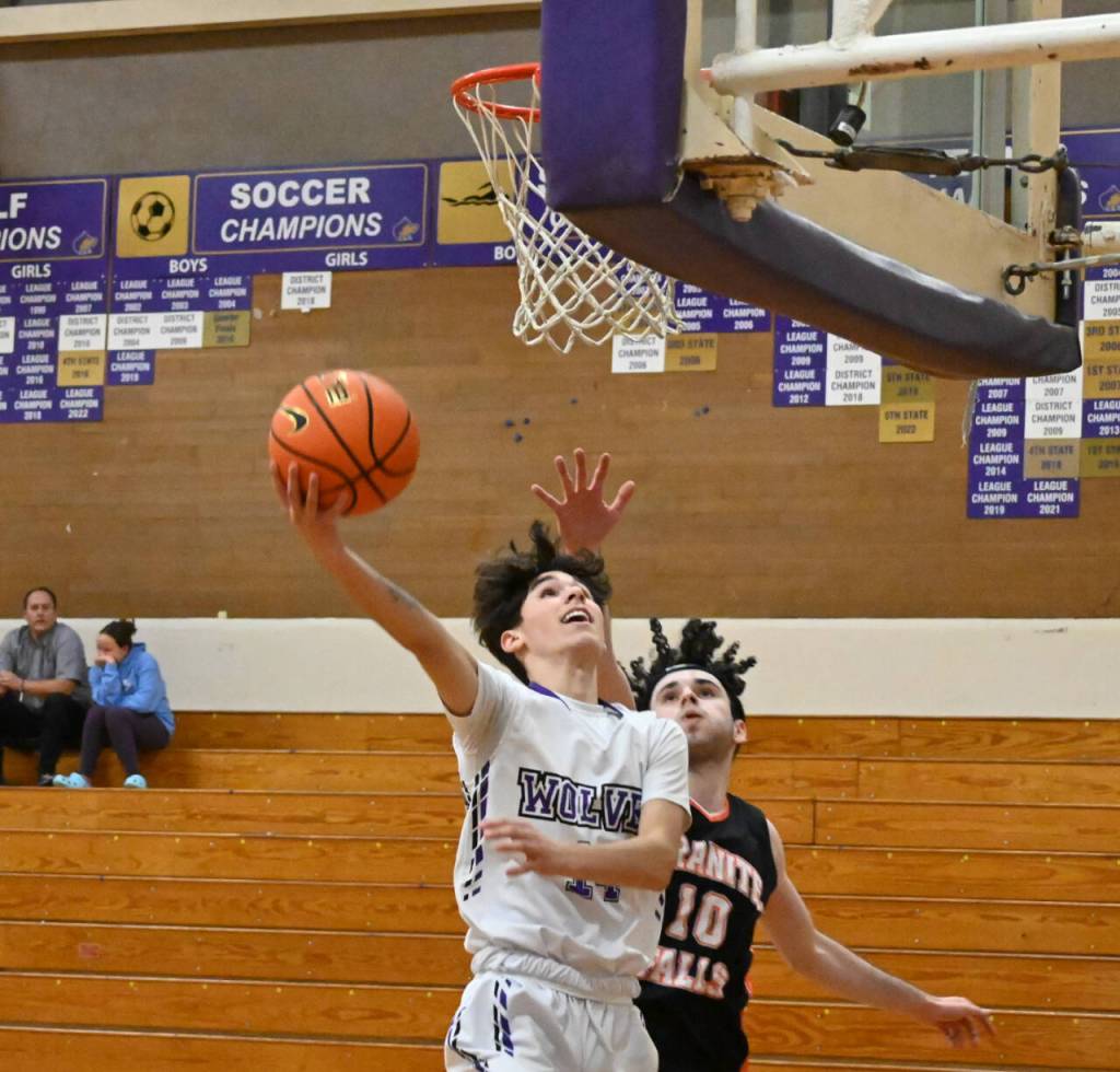 Sequim Gazette photo by Michael Dashiell / Sequim guard Vince Carrizosa drives to the basket past Granite Falls Marcus Klammt in the first half of the Wolves 78-43 win over the visiting Tigers on Dec. 29. Carrizosa had a team-high 15 points.