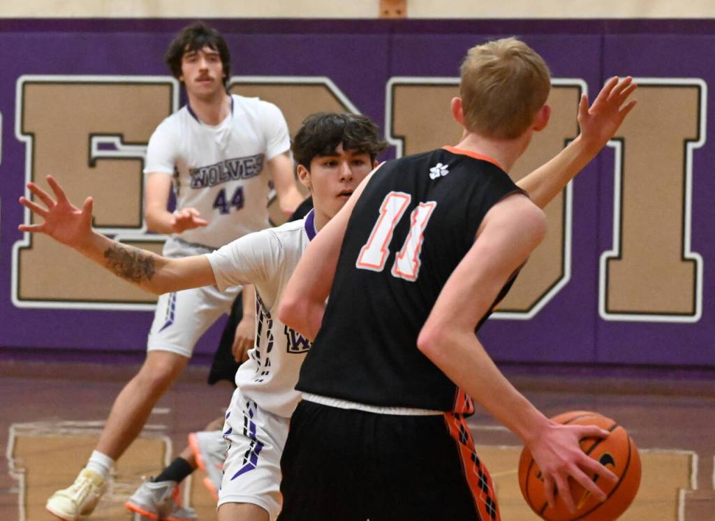 Sequim Gazette photo by Michael Dashiell 
Sequim guard Vince Carrizosa , center, and Cole Smithson guard the basket against Jack McGill and the visiting Granite Falls Tigers on Dec. 29. Sequim won, 78-43.