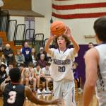 Sequim Gazette photo by Michael Dashiell / Sequims Garrett Little, center, feeds a pass to teammate Espn Judd as Granite Falls Javario Adams guards the play in a Dec. 29 non-league game in Sequim. Sequims Wolves won, 78-43.
