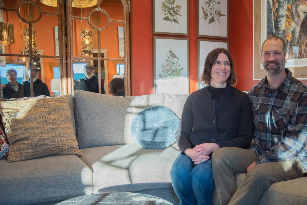 Sequim Gazette photo by Emily Matthiessen / Jeri and Fran Sanford are reflected in some of Over the Fences many mirrors behind the couch where their daughter Emily Underwood and son-in-law Scott Underwood sit, happy new owners of the iconic Sequim store.