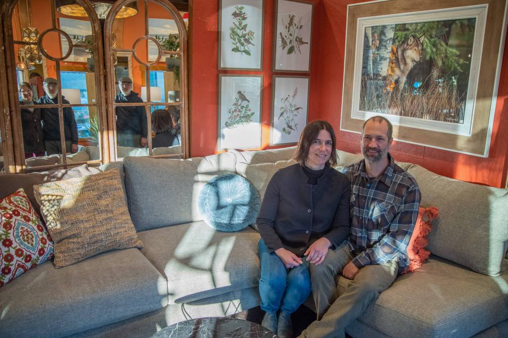 Sequim Gazette photo by Emily Matthiessen / Sequim Gazette photo by Emily Matthiessen / Jeri and Fran Sanford are reflected in some of Over the Fences many mirrors behind the couch where their daughter Emily Underwood and son-in-law Scott Underwood sit, happy new owners of the iconic Sequim store.