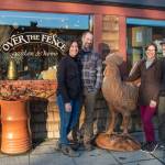Sequim Gazette photo by Emily Matthiessen / Emily Underwood stands with her husband Scott Underwood, left, and her parents Jeri and Fran Sanford stand on the other side of Over the Fences giant metal rooster. The end of 2022 marks the transition of ownership of the store between the two couples.