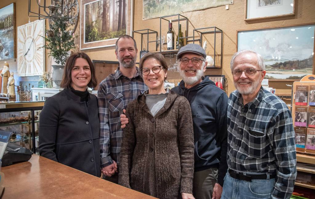 Sequim Gazette photo by Emily Matthiessen / Over the Fences new owners Emily and Scott Underwood stand behind the counter with Emilys parents Jeri and Fran Sanford and store accountant Clive Donaldson. All the current staff will remain working at the store.