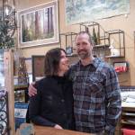 Sequim Gazette photo by Emily Matthiessen / Held by her husband and business partner Scott, Emily Underwood smiles at her parents Jeri and Fran Sanford (not in picture). The Underwoods are the new owners of Over the Fence in Sequim, which they bought from the Sanfords, who plan to visit with friends, travel, garden and have other fun during their retirement, as well as help out at the store occasionally.