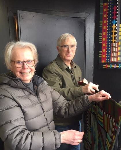 Submitted photo
Jeri Auty, Port Ludlow, and Harry Cook, husband of Sequim artist Kathie Cook, install art quilts at 675 Tyler St., Port Townsend, in the walk-by exhibit maintained by members of Peninsula Fiber Artists. Working in a Series will be on exhibit until March 3.