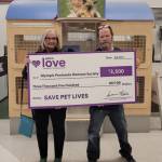 Submitted photo
Luanne Hinkle, Olympic Peninsula Humane Societys executive director, accepts a $3,500 grant investment from national nonprofit Petco Love from Sequim Petco general manager Steve Dale in November.