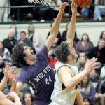 Photo by Keith Thorpe/Olympic Peninsula News Group / Sequims Cole Smithson, left, battles at the boards with Port Angeles Isaiah Shamp during a Jan. 10 Olympic League game at Port Angeles High School.