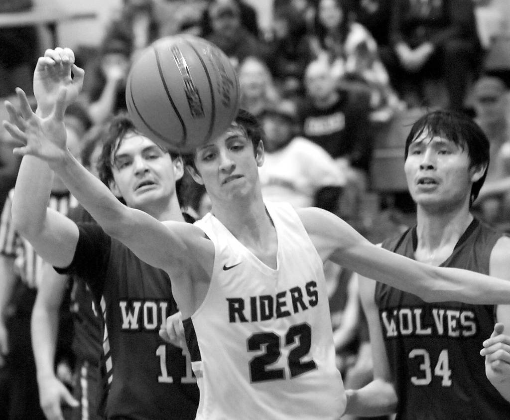 Port Angeles Tyler Hunter, center, watches a ball get away as Sequims Charlie Grider, left, and Isaiah Moore right, look on during a Jan. 10 Olympic League game in Port Angeles.