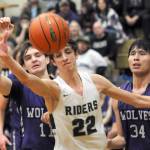 Port Angeles Tyler Hunter, center, watches a ball get away as Sequims Charlie Grider, left, and Isaiah Moore right, look on during a Jan. 10 Olympic League game in Port Angeles.