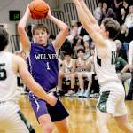 Sequims Zackary Thompson looks for a passing opportinity as Port Angeles Parker Nickerson, left, and Josiah Long close in on Jan. 10 in Port Angeles.