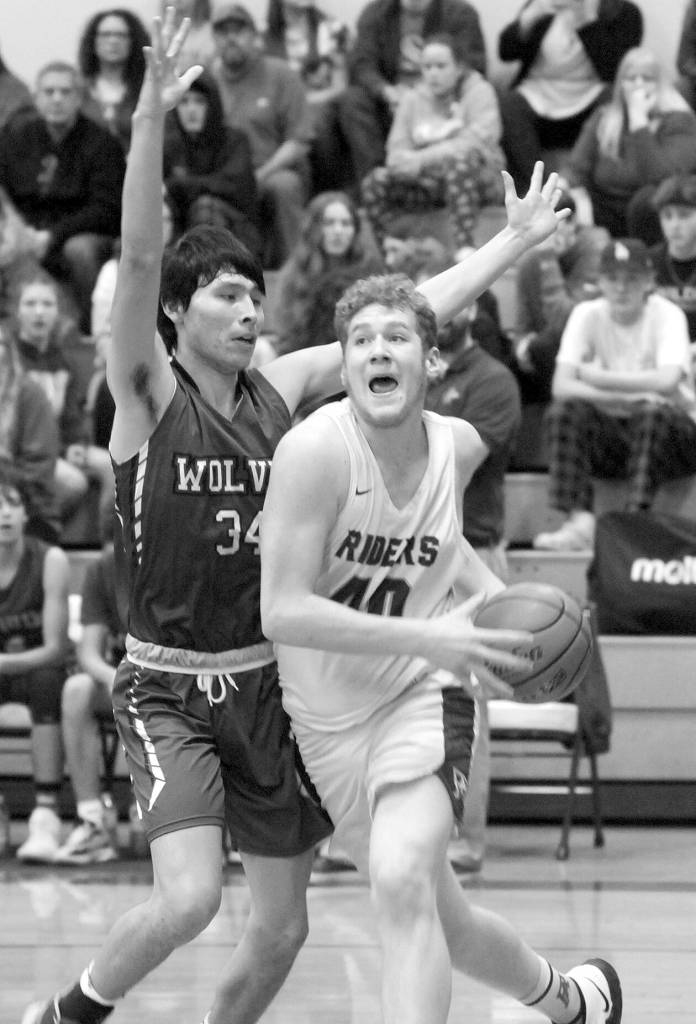 Photos by Keith Thorpe/Olympic Peninsula News Group
Port Angeles Isaiah Shamp, right, pushes past Sequims Isaiah Moore on the way to the lane on Jan. 10 in Port Angeles.