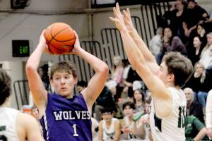 KEITH THORPE/PENINSULA DAILY NEWS
SEquim's Zackary Thompson looks for a passing opportinity as Port Angeles' Parker Nickerson, left, and Josiah Long close in on Tuesday at Port Angeles High School.