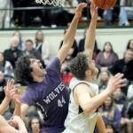 Photo by Keith Thorpe/Olympic Peninsula News Group / Sequims Cole Smithson, left, battles at the boards with Port Angeles Isaiah Shamp during a Jan. 10 Olympic League game at Port Angeles High School.