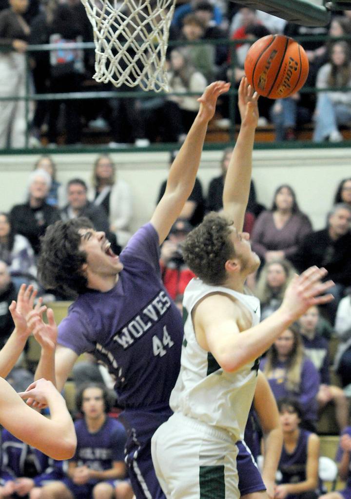 Photo by Keith Thorpe/Olympic Peninsula News Group / Sequims Cole Smithson, left, battles at the boards with Port Angeles Isaiah Shamp during a Jan. 10 Olympic League game at Port Angeles High School.