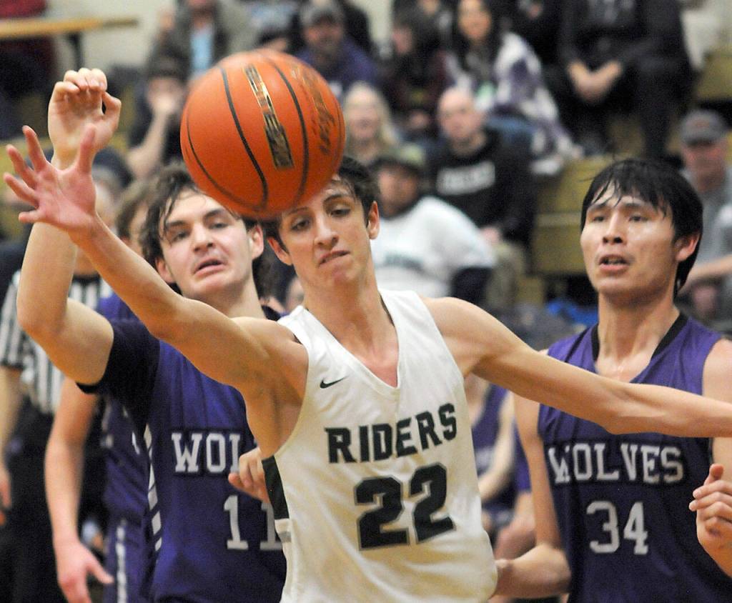 Port Angeles Tyler Hunter, center, watches a ball get away as Sequims Charlie Grider, left, and Isaiah Moore right, look on during a Jan. 10 Olympic League game in Port Angeles.