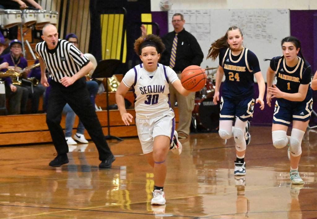 Sequim Gazette photo by Michael Dashiell / Sequim guard Bobbi Mixon, left, races downcourt for a score in the fourth quarter of a 38-31 SHS win over visiting Bainbridge. Chasing Mixon are Spartans Bella Ramirez (24) and Bella Ramirez.