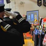 Firefighters pay tribute to Capt. Charles Chad Cate at a memorial service at Sequim High School on Jan. 21.