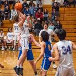 Sequim Gazette photo by Emily Matthiessen / Sequims Zack Thompson looks to score in a Jan. 17 Olympic League home game against Bremerton. Looking on are teammates Cole Smithson (background) and Isaiah Moore (34).