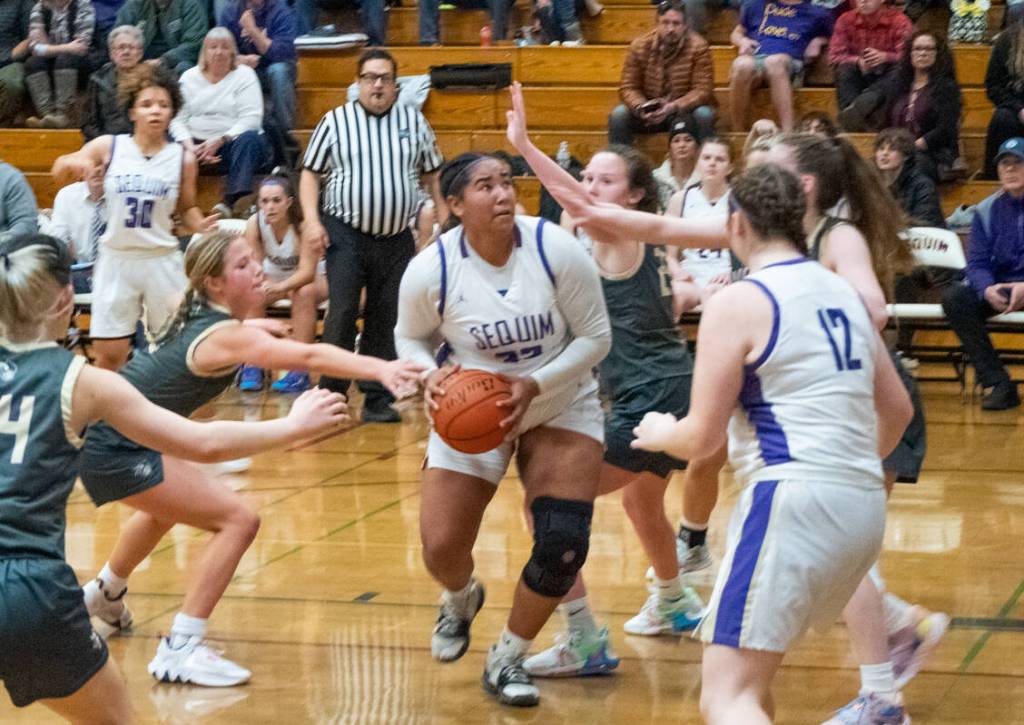 Sequim gazette photo by Emily Matthiessen / Sequim senior Jelissa Julmist, center, is surrounded by Vikings in SHSs 64-49 home win over North Kitsap on Jan. 19. Julmist finished with 12 points, eight rebounds, seven assists and six steals.